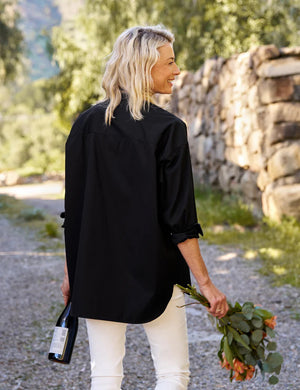 Displayed against a white backdrop is the FRANK AND EILEEN - VICTORIA ITALIAN TUXEDO SHIRT in black, featuring long sleeves and a woven jacquard bib. Inside, the label reads "Frank Kelleron Est. 1947." This luxurious Italian piece boasts a formal front panel, slightly rounded hem, and buttoned cuffs.