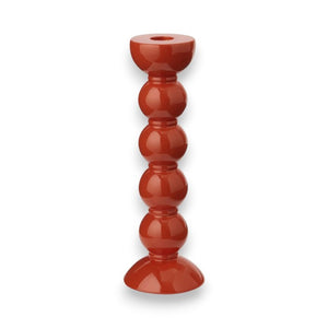 The ADDISON ROSS LONDON - TALL BOBBIN CANDLESTICK 24CM features a stacked design of four spherical shapes, ascending from a wide, rounded base to a smaller, flat top. The lacquered orange holder has a glossy finish and is displayed against a white background.