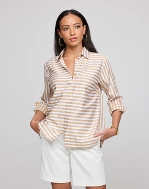 A woman with long dark hair stands with her back to the camera, highlighting a classic look: the HINSON WU Wena 3/4 Sleeve Top in Stripe Gingham Combo, featuring rolled-up sleeves and a visible back zipper. She complements this with hoop earrings and bracelets, paired perfectly with crisp white pants.