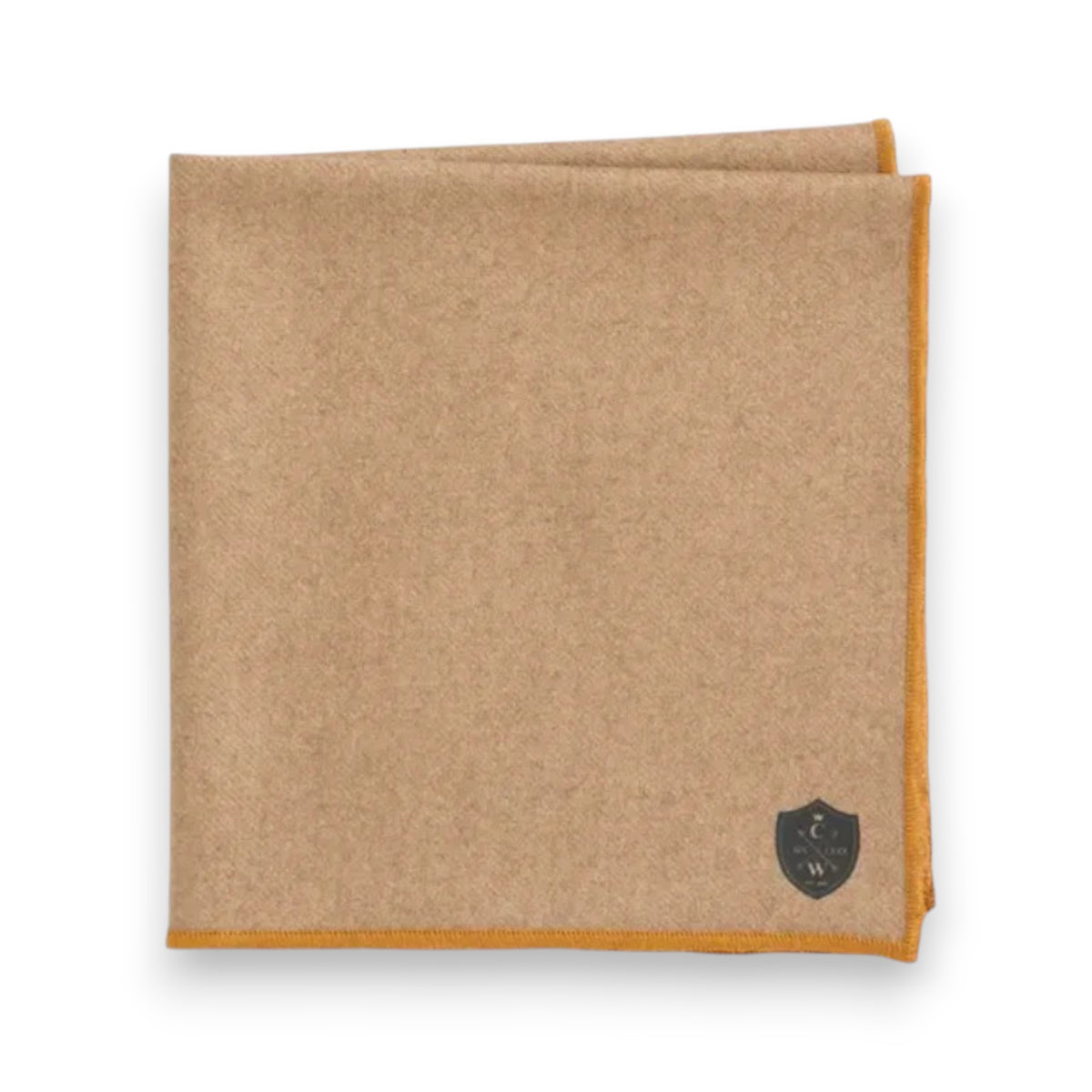 The CLIFTON WILSON Cashmere Pocket Square features light brown cashmere, a dark crest logo in one corner, mustard-yellow trim, and is crafted in Italy for refined elegance.