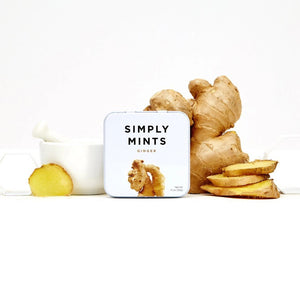 A square metal tin from SIMPLY GUM features a minimalist design with a white background. The words "Simply Mints" are displayed in black, and "Ginger" is highlighted in gold beneath it. Below the text, there’s an image of fresh ginger root, emphasizing its refreshing fall flavor. The tin has a net weight of 1.1 oz (30g).