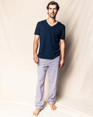 The FEARRINGTON LIFESTYLE COLLECTION - MEN'S TWILL PAJAMA PANT IN NAVY FRENCH TICKING by PETITE PLUME is a pair of pajama pants adorned with white and blue vertical stripes. Made from the finest quality cotton, these luxurious pants feature a black drawstring waist and black trim at the cuffs. Laid flat on a white background, they proudly display their elegant French ticking design.