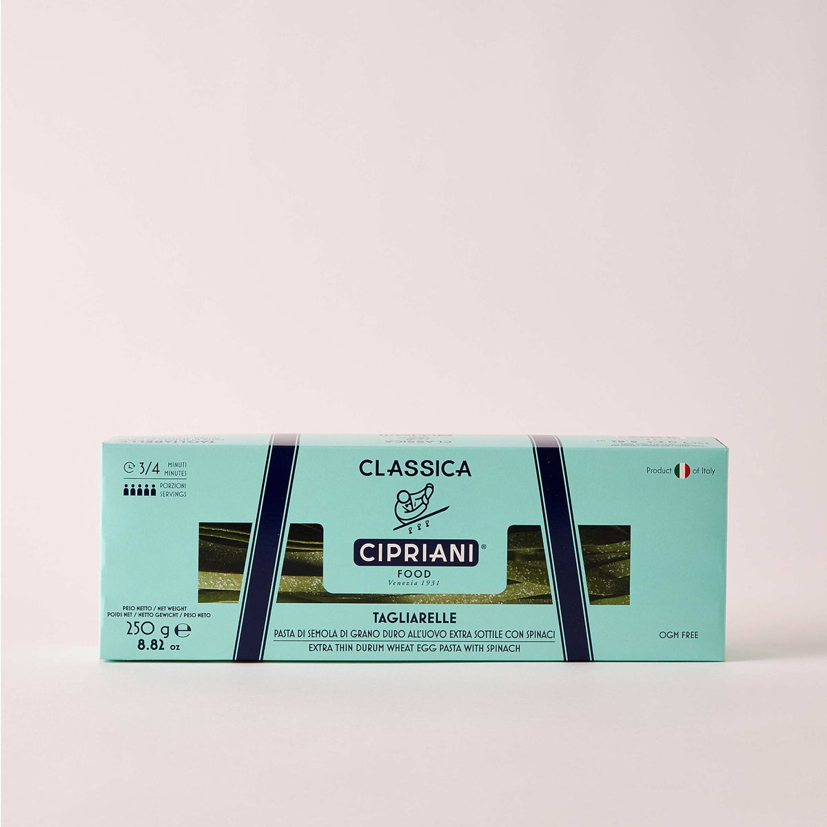 A close-up view of uncooked CIPRIANI - ORGANIC EGG TAGLIARRELLE PASTA WITH SPINACH from ATALANTA CORPORATION. The green-colored egg pasta strands, reminiscent of artisanal pasta, are coated with flour and are arranged in a slightly overlapping manner, showcasing their flat and wide shape.