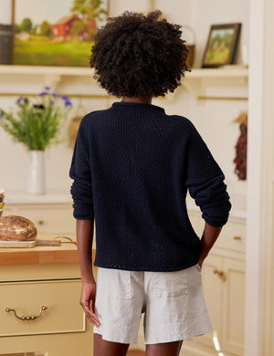 The FRANK & EILEEN MONTEREY Pointelle Rolled Funnel Neck Sweater in Marine features a loose, textured Italian pointelle knit, long sleeves, high rolled neckline, and is crafted from 100% cotton. Shown laid flat on a white background.