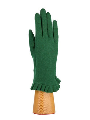 A green, wool knit glove from Santacana Madrid World Glove Company is showcased upright on a wooden hand-shaped stand, featuring a simple pleated trim around the wrist.