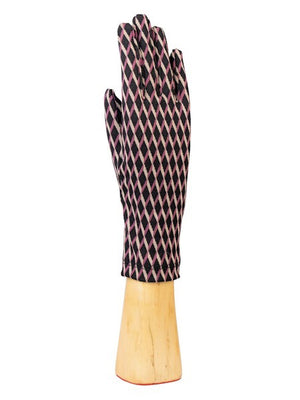 A wooden hand mannequin showcases the STRETCH KNIT DIAMOND PRINT GLOVE by SANTACANA MADRID WORLD GLOVE COMPANY, featuring a pink and black diamond design. The glove, with its cozy wool lining, is displayed upright to emphasize its stylish comfort.