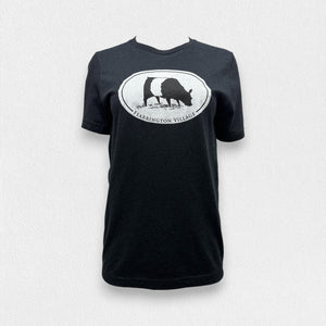 A black triblend unisex tee from the FEARRINGTON LIFESTYLE COLLECTION by GILDAN, showcasing a white oval logo with a silhouette of a goat and the text "FEARRINGTON VILLAGE" underneath, set against a plain light gray background.