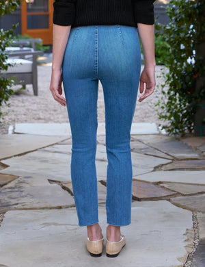 A pair of blue Frank & Eileen Derry Illusion Pull On Pants with a slim-straight fit. The pants feature subtle fading along the front and no visible pockets or detailing on the front, offering a clean, simple design with a modern, casual look.