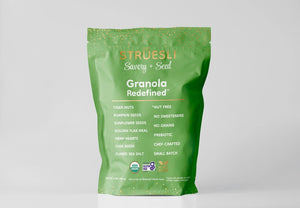 The image features a green bag of STRUESLI - SAVORY SEED GRANOLA with white and orange text. The front highlights key ingredients and attributes, including tiger nuts and pumpkin seeds, noting that it contains no sweeteners and is chef-crafted. It also prominently displays its gluten-free, Paleo certifications, and keto-friendly nature.