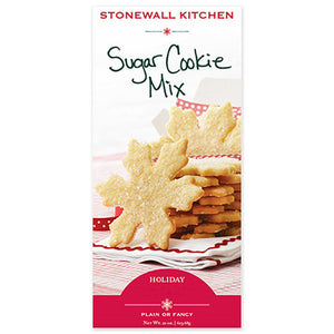 A box of STONEWALL KITCHEN - SUGAR COOKIE MIX presents a plate adorned with snowflake-shaped sugar cookies made using cookie cutters. The words "Holiday" and "Plain or Fancy" are tastefully featured at the bottom.