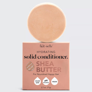 The image showcases a SHEA BUTTER CONDITIONER BAR from the brand KITSCH. The packaging, labeled "Hydrating Solid Conditioner Shea Butter," highlights its color-safe, pH balanced, and vegan properties. Perfect for frizz control, this plastic-free conditioner sits neatly on top of the box.