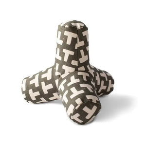 The FRINGE STUDIO - ODETTE OLIVE CANVAS SQUEAKER DOG TOY by PET SHOP BY FRINGE STUDIO is a plush toy designed in the shape of a three-pronged jack. Made from durable cotton canvas, it is covered with an olive fabric featuring a pattern of white "T" letters scattered across the surface. Utilizing non-toxic inks, this soft-textured toy offers both comfort and fun for your pet.