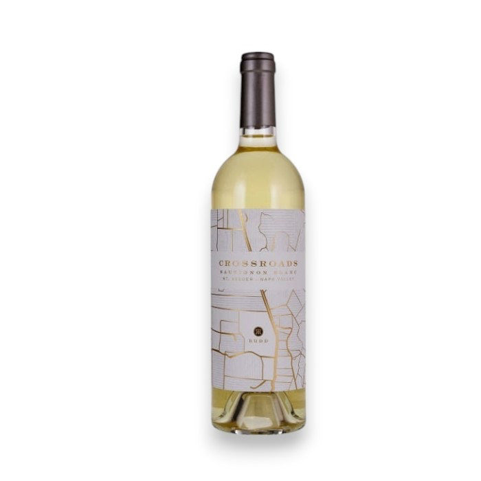 A bottle of RUDD 'CROSSROADS' Sauvignon Blanc 2022 from WINE: GRAPEVINE features abstract line art with gold accents on the label, a metallic screw cap with "MUDD" prominently displayed, and a nod to Martha's Vineyard.