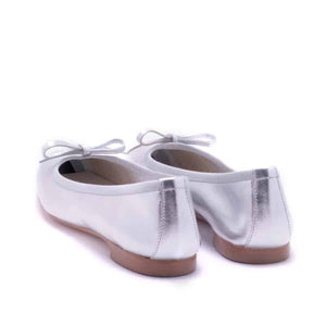 The MICHELE LOPRIORE - PALOMA ballet flat with a square toe, crafted from genuine silver leather, features a delicate bow on the front and a low-profile brown sole. Made in Italy, this elegant shoe is set against a plain white textured background.