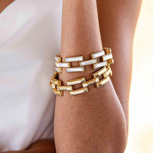 A close-up view of the CAPUCINE DE WULF - PATHWAY LINK BRACELET, GOLD showcases its handcrafted rectangular, textured links connected in a bold geometric pattern. This 18K gold bracelet features a shiny finish and clasp closure from the esteemed brand, CAPUCINE DE WULF.