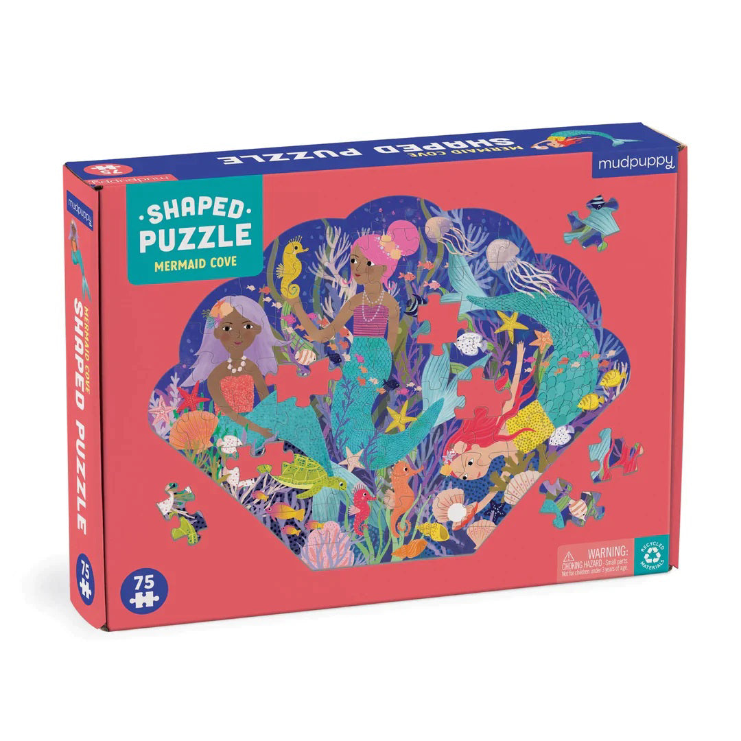 The image depicts the box of a seashell-shaped puzzle titled &quot;Mermaid Cove Puzzle&quot; by Petit Collage. The box features vibrant illustrations of mermaids and underwater scenery, including various sea creatures and plants. This 75+ piece recycled paper puzzle is designed for ages 4 and up.