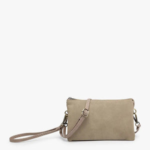 The SUEDE WRISTLET CROSSBODY by JEN & CO is a minimalist mustard yellow clutch made from faux suede. It includes a detachable strap, silver hardware, and has a zippered closure, all displayed on a plain white background.