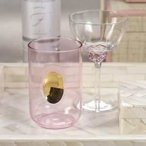 Product Description: The MARTINI COCKTAIL OPTIC GLASS set by ZODAX includes a rectangular wicker tray with metal handles, holding four stylishly crafted glass goblets, each featuring a vibrant decorative element on the stem. Ideal for serving drinks with flair, this elegant ensemble is showcased on a light gray surface.