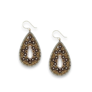 A single pear-shaped earring from the MIGUEL ASES - SWAROVSKI MIYUKI PEAR SHAPE EARRINGS collection by MIGUEL ASES, INC., featuring gray and bronze beads in an intricate pattern, is set against a white textured background. Handcrafted in America, the earring includes a delicate hook for wearing and boasts elegant 14K gold-fill details.