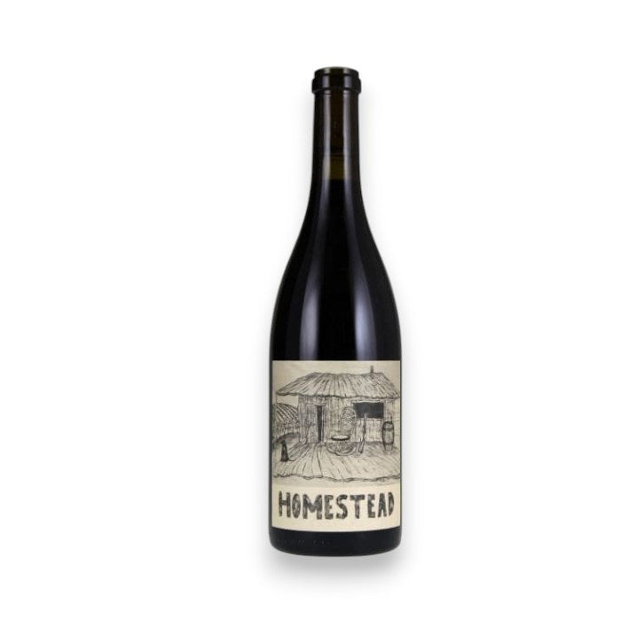 A dark wine bottle with a cream label featuring "HOMESTEAD" in bold and a rustic cabin illustration represents the BIG BASIN HOMESTEAD GRENACHE BLEND 2019 by JOHNSON BROS./MUTUAL/EPIPHANY, offering vibrant red fruit notes.