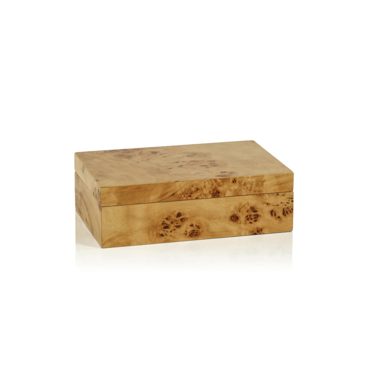 A faceted glass with a brown and cream pattern rests on the ZODAX BURL WOOD DESIGN BOX - SMALL, stacked atop another decorative box, all arranged on a coffee table book titled &quot;Italian Chic.