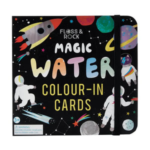 The FLOSS AND ROCK - SPACE WATER PEN AND CARDS by FLOSS & ROCK is an open children's educational activity book with color-in cards, featuring sections labeled "Numbers," "Scenes," and "Words." The book also includes a "Magic Water" coloring section with a spaceship and astronaut drawing, making it an exciting gift. Bonus: it comes in a reusable carry case!