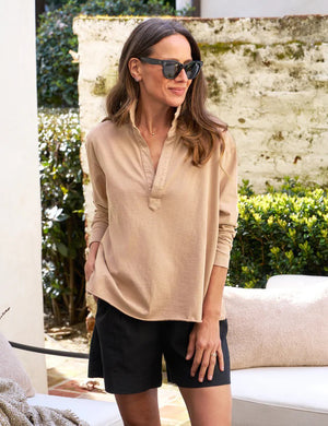 A long-sleeved, light beige FRANK & EILEEN Patrick Popover Henley shirt in Heritage Jersey with a V-neck opening and a cropped hem, laid flat against a white background. The label inside the collar is partially visible, and the shirt appears casual and slightly wrinkled.