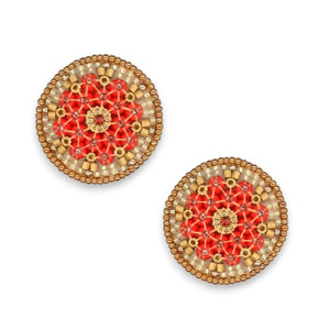 A circular decorative brooch from the Miguel Ases Collection showcases intricate beadwork in a stunning radial pattern. At its center is a gold design, encircled by red beads and bordered by alternating gold and beige beads. The entire piece, set against a plain white background, exudes the same elegance found in MIGUEL ASES - SWAROVSKI MIYUKI RONDELLE EARRINGS by MIGUEL ASES, INC.