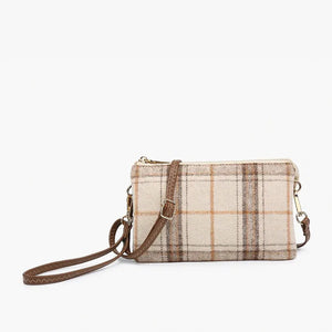 The PLAID CROSSBODY WRISTLET by JEN & CO boasts a blue plaid design on vegan leather, showcasing a grid pattern with brown lines against a plain white background. It features a detachable strap and zipper closure, highlighted by gold-tone hardware on the wristlet strap.