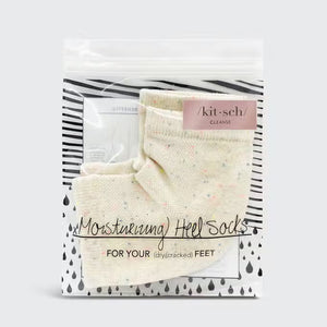 A pair of MOISTURIZING HEEL SOCKS by KITSCH in an off-white color with small, colorful speckles are laid out side by side on a gray background. These socks feature a ribbed cuff and are designed to fit over the ankle, ensuring a smooth feel for delicate skin.