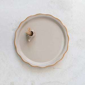 A STONEWARE PLATE WITH HEDGHOG TOOTHPICK HOLDER by CREATIVE COOP features a round, beige stoneware plate with a wavy rim and a brown edge, while the whimsical hedgehog toothpick holder adds charm to its simple elegance.