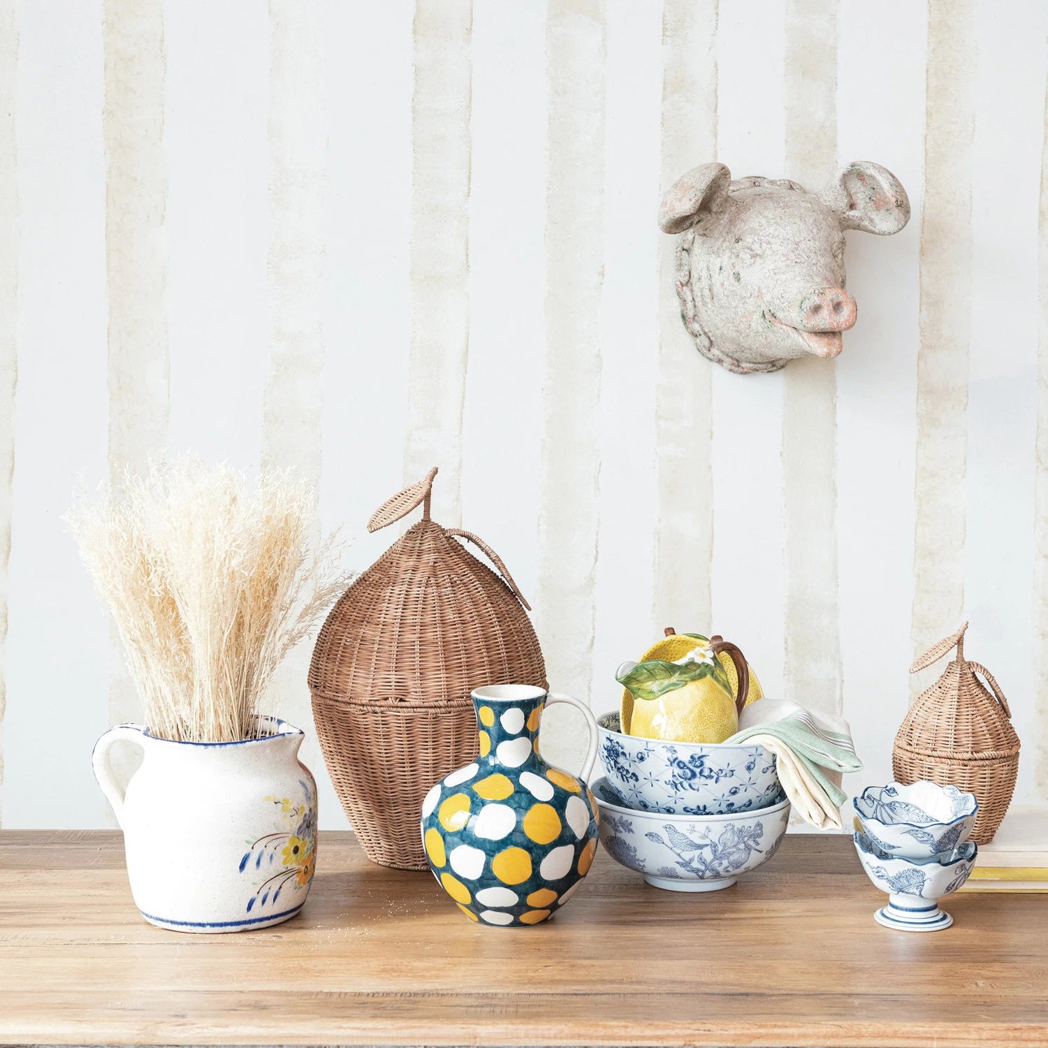 The HAND STAMPED PORCELAIN BOWL WITH BIRDS by CREATIVE COOP is a set of white stoneware bowls adorned with intricate blue botanical and bird designs. In the images, one bowl is presented in a top-down view, showcasing its detailed inner hand-stamped pattern, while the other is displayed from the side to emphasize its exterior design. Both bowls are photographed against a plain white background.