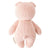 A pink knitted baby piglet, crafted from 100% cotton yarn, is shown from the back. It has small round ears, arms, a tail, and a tag attached to its side. The piglet boasts a simple, cuddly design and radiates the charm of hand-knit baby animals while supporting fair trade income. This delightful creation is known as the CUDDLE + KIND - HANDMADE BABY PIGLET by CUDDLE & KIND.