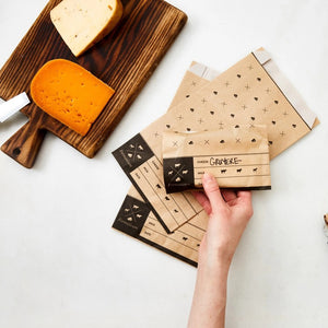 The Formaticum product packaging box for cheese storage bags is perfect for keeping cheese fresh at home. The box has a mainly white design with black accents and text, displaying icons of various cheese shapes. The text reads "FORMATICUM - CHEESE STORAGE BAGS" and indicates that it contains 15 bags.