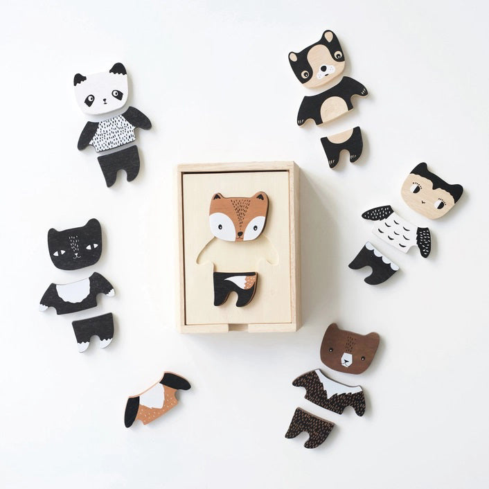 A wooden toy set titled &quot;WEE GALLERY - MIX &amp; MATCH ANIMAL TILES&quot; by WEE GALLERY shown on a white background. The visible toy piece features a cartoonish animal, combining traits of a fox and a bear, painted in brown, white, and black colors. Perfect for creative play and developing motor skills, the toy is presented in a wooden box.