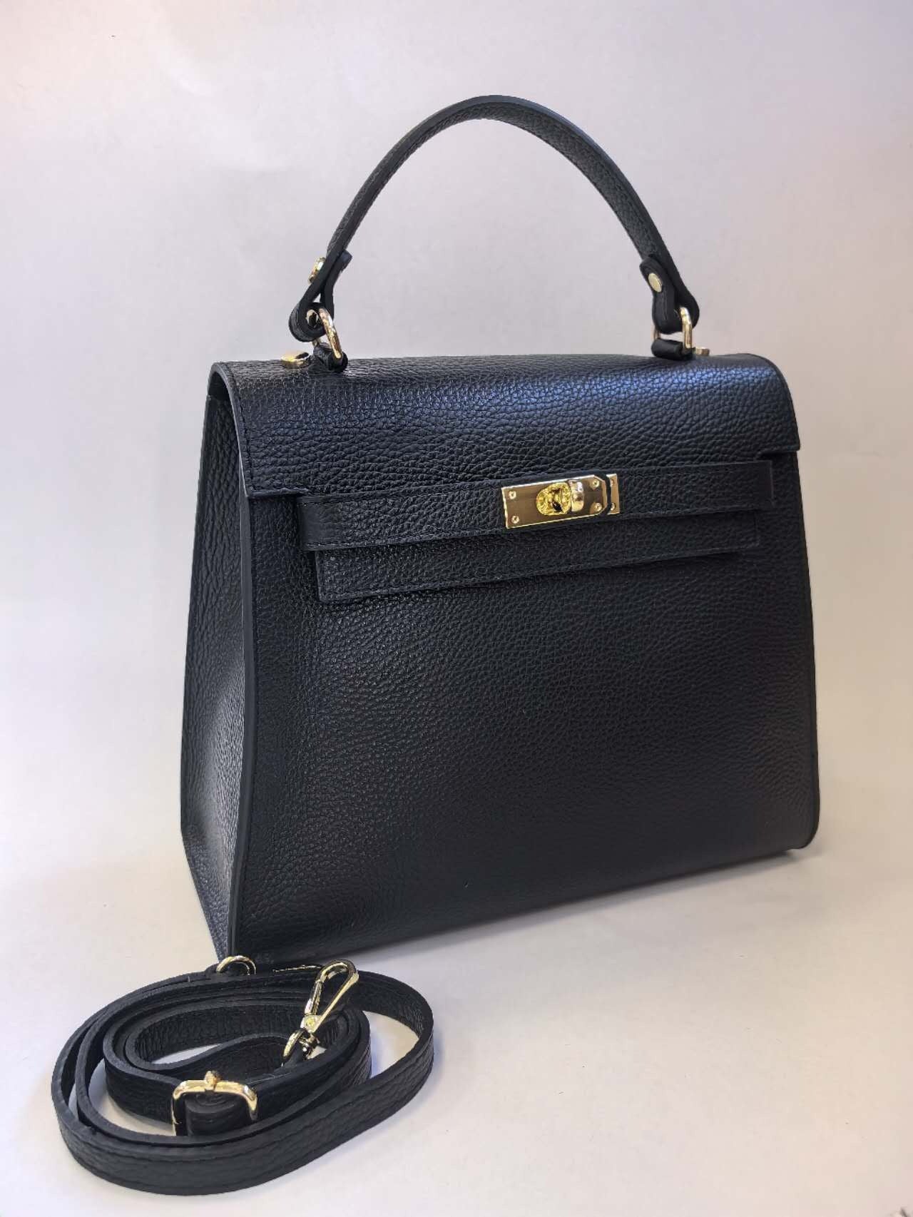 The MONDO BORSE LEATHER SATCHEL HANDBAG, made from black, textured genuine leather, features a gold-toned turn-lock closure and a top handle. Made in Italy, it comes with a detachable front strap for shoulder or crossbody wear, all set against a neutral, light-colored backdrop.