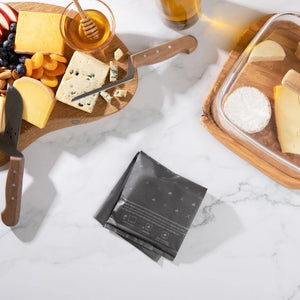 A white box featuring text and illustrations, branded "FORMATICUM" at the top, with three small icons of a goat, cow, and sheep beneath it. The product is identified as "FORMATICUM - REUSABLE CHEESE STORAGE BAGS," designed to maintain freshness. It contains 10 bags and measures 10" x 16" (25 cm x 41 cm).