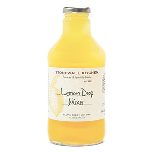 A bottle of STONEWALL KITCHEN - LEMON DROP MIX, featuring a yellow label with a lemon illustration and text that reads "Lemon Drop Mixer" along with "Gluten Free, Non-GMO." The bottle contains 24 fl oz (710 ml) of liquid, perfect for elevating your favorite cocktails with its refreshing taste.