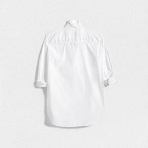 A FRANK AND EILEEN - FRANK CLASSIC BUTTON-UP SHIRT SUPERFINE POPLIN in white, featuring a classically tailored long-sleeve design with rolled-up sleeves, is displayed against a plain, textured background. The label inside the collar reads "FRANK & EILEEN." This shirt offers a classic, slightly relaxed fit with a curved hemline and bust-flattering button placement.