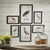 The NAPA HOME AND GARDEN - WATERFOWL GALLERY ART MEDIUM collection displays six vintage-style framed bird illustrations, including aquatic birds, on a white wall. These unique prints are arranged in a balanced rectangular pattern.