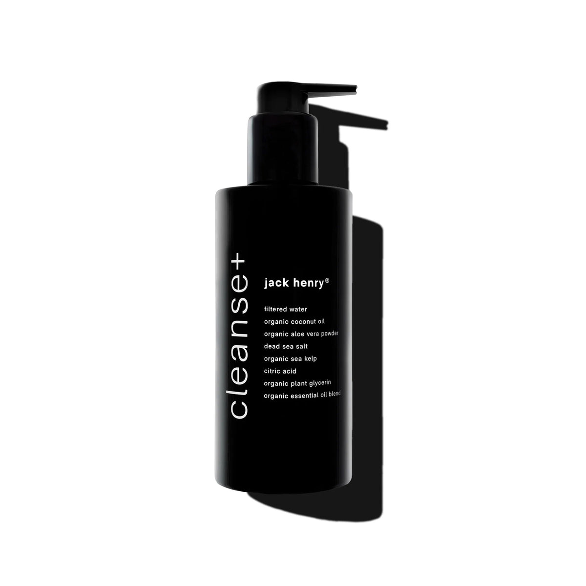 A sleek black pump bottle labeled &quot;JACK HENRY - CLEANSE+ FACE&quot; features hydrating botanicals and natural ingredients. Photographed on a white background with a bold shadow, this all-in-one cleanser combines purity and simplicity.