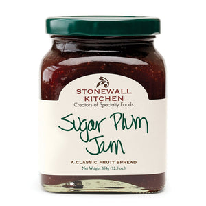 A jar of STONEWALL KITCHEN - SUGAR PLUM JAM is showcased, ideal for holiday treats. The label describes it as "a classic fruit spread" and has a net weight of 354g (12.5 oz). The jar comes with a green lid, and the jam inside is a deep red color.