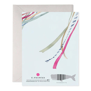 The WEDDING RIBBONS GREETING CARD by E.FRANCES PAPER features vibrant ribbons resembling a watercolor painting on a soft background. Embellished with gold writing, it beautifully states "On your beautiful wedding day." Accompanied by a partially visible envelope, this card completes the delightful wedding greeting experience.