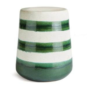 The NAPA HOME AND GARDEN - LIA STOOL is a whimsical ceramic with a tapered cylindrical shape featuring green and white horizontal stripes in gradient patterns. Varying shades of green mimic natural elements, creating enchanting hue variations.