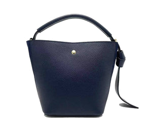 Introducing the SMALL LEATHER BUCKET HANDBAG by LE BORSETTE: This sleek white handbag boasts a structured design with a single top handle and detachable crossbody straps. With its minimalistic style and tiny gold accent on the front, its clean lines and smooth texture provide a modern, sophisticated look.