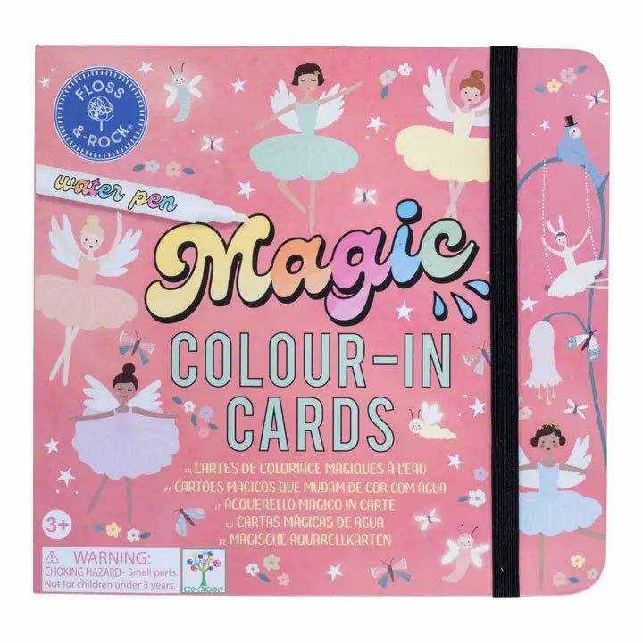 A colorful, fairy-tale-themed illustration shows a stage with dancing ballerina fairies, a smiling moon, and a fox in a dress. A white pen labeled &quot;FLOSS &amp; ROCK&quot; lies diagonally across the image. This travel-friendly toy, known as the FLOSS AND ROCK - ENCHANTED WATER PENS AND CARDS, includes reusable water cards adorned with stars and whimsical designs.