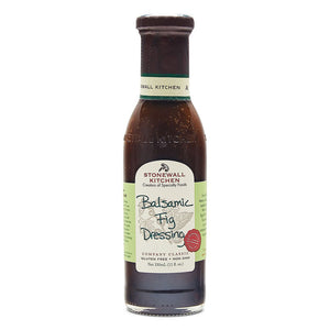 A bottle of STONEWALL KITCHEN-BALSAMIC FIG DRESSING features the product name on a dark bottle with a green label. This delicious gluten-free and non-GMO salad dressing comes in an 11 fl. oz (330 ml) size.