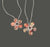 The ANN LIGHTFOOT - PETITE RED SPOTTED CHALCEDONY FLOWER NECKLACE showcases five marbled stones in warm browns and reds, resembling faceted spotted red chalcedony, elegantly held by silver wire and suspended from an adjustable braided nylon tie.