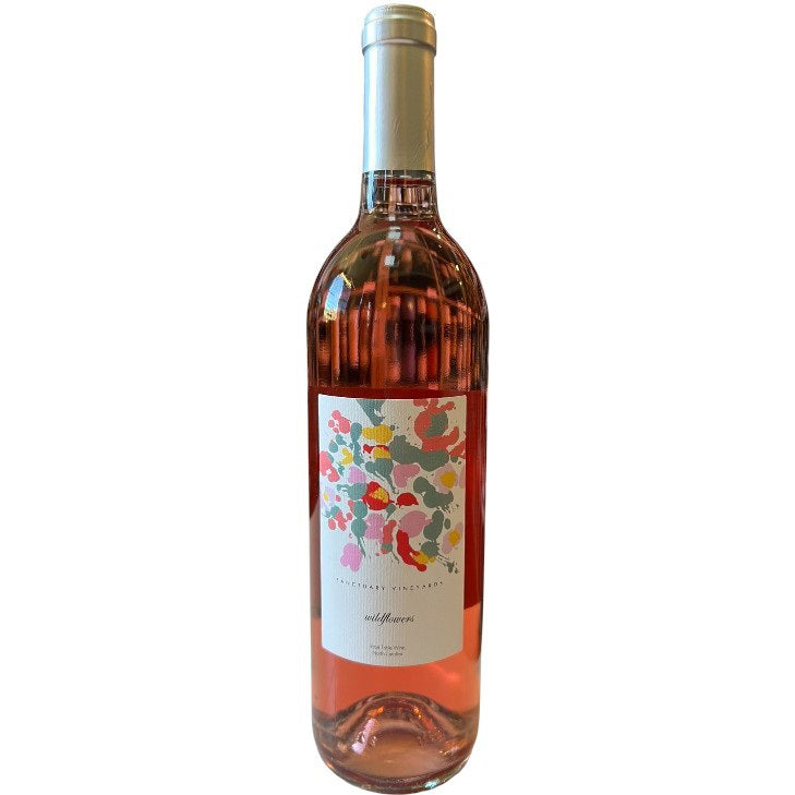 Enjoy a bottle of SANCTUARY &#39;WILDFLOWERS&#39; ROSÉ by WINE: FREEDOM BEVERAGE—light pink with a white label featuring colorful abstract flowers and a gold foil cap, perfect for experiencing North Carolina&#39;s unique wine flavors.