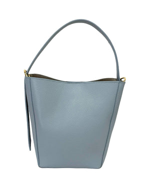 The LEATHER BUCKET BAG by LE BORSETTE in light blue leather showcases minimalist sophistication with its single strap. Its smooth texture is accentuated by subtle pebble grain detailing, and gold-tone hardware elegantly attaches the strap on either side.